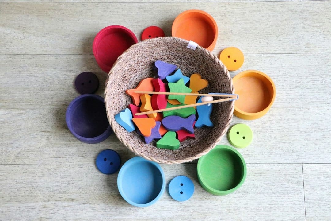 Colorful wooden educational toys spilling from a woven basket.